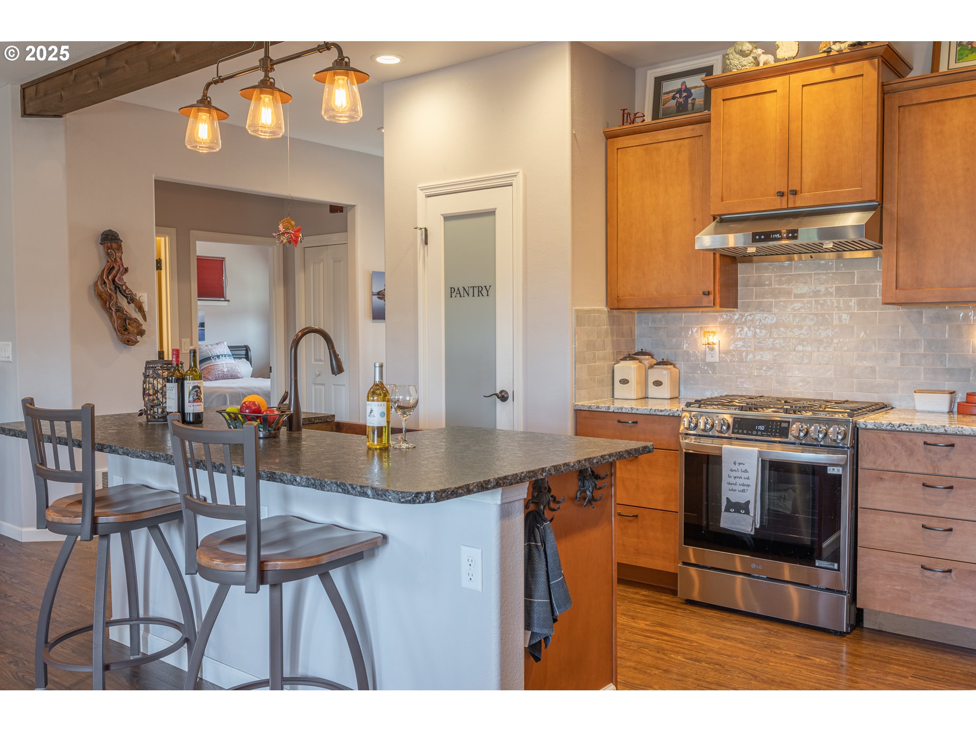 2686 Cedar Loop Bandon, OR 97411 - Photo 18 of 42 a kitchen with stainless steel appliances a stove a sink and a dining table