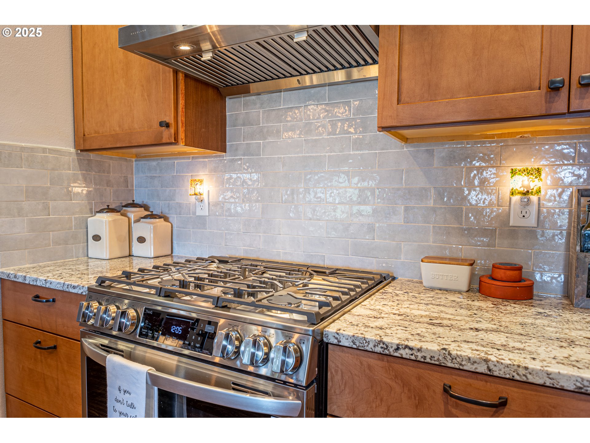 2686 Cedar Loop Bandon, OR 97411 - Photo 20 of 42 a kitchen with granite countertop a stove and a wooden cabinets