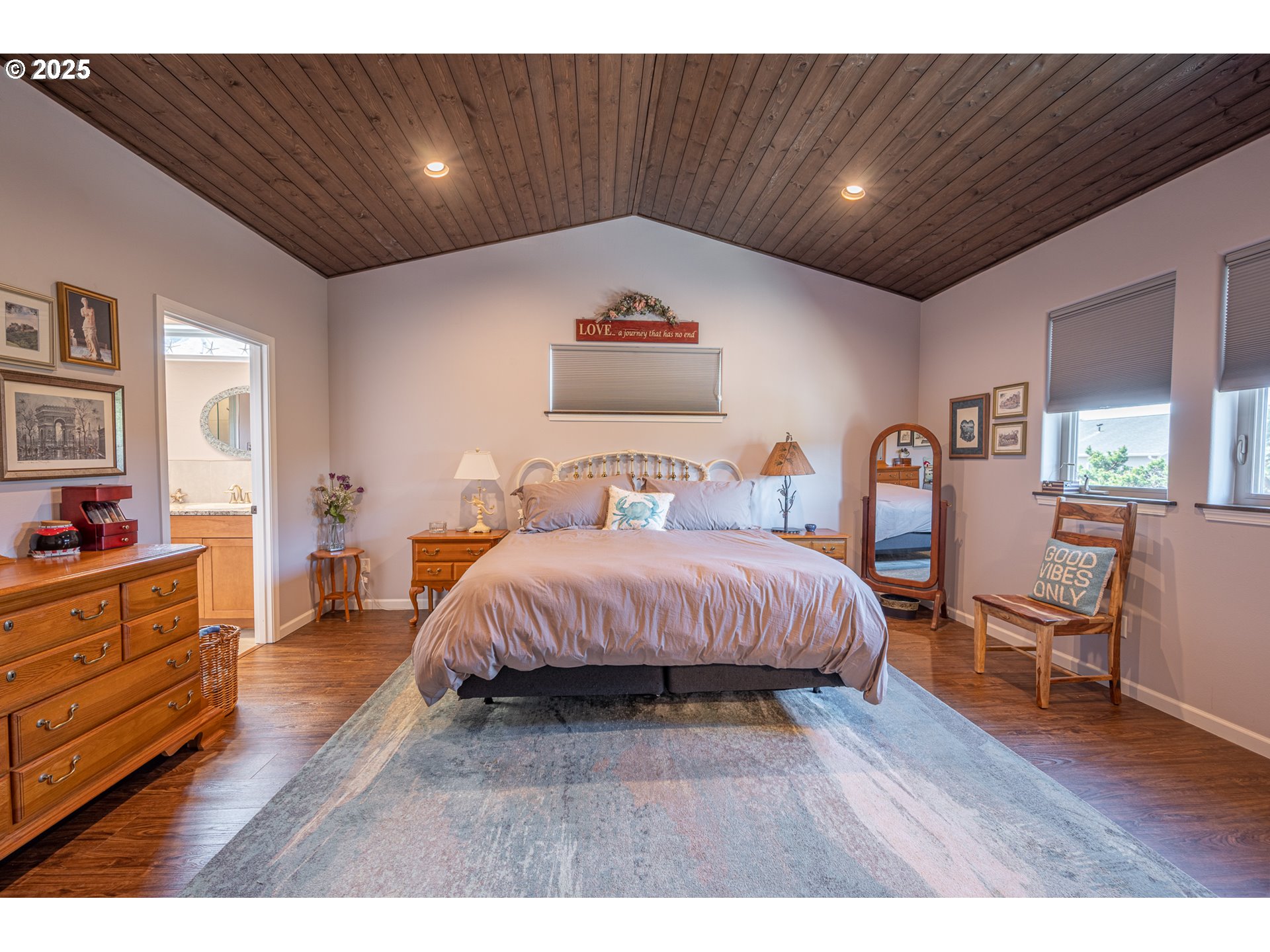 2686 Cedar Loop Bandon, OR 97411 - Photo 23 of 42 a spacious bedroom with a bed and wooden floor