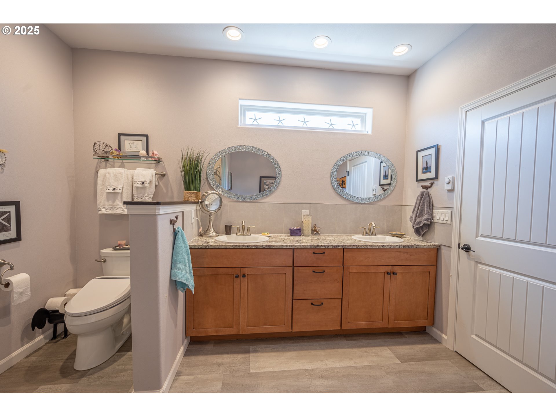 2686 Cedar Loop Bandon, OR 97411 - Photo 26 of 42 a bathroom with a toilet a sink and mirror