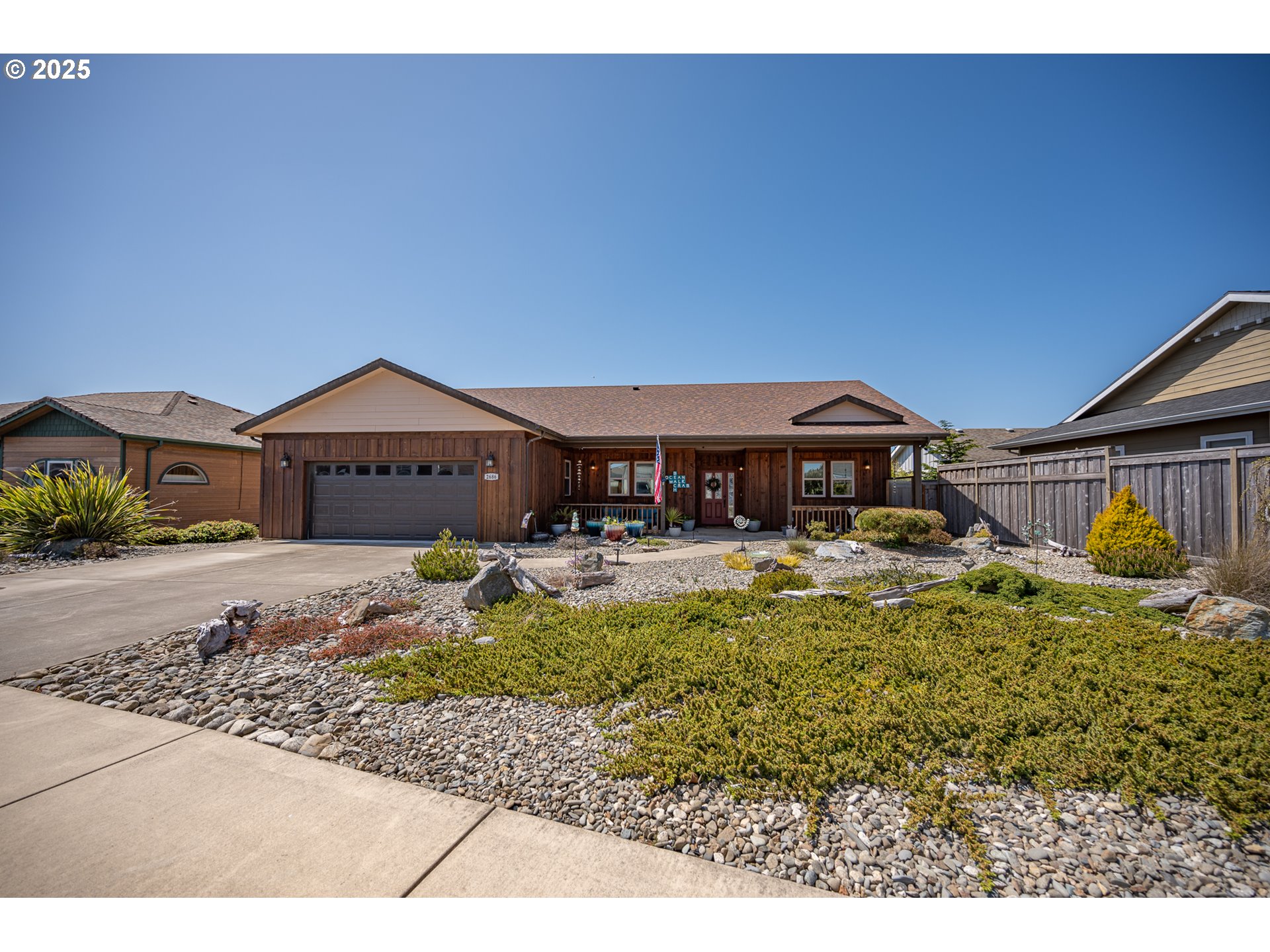 2686 Cedar Loop Bandon, OR 97411 - Photo 3 of 42 a front view of a house with swimming pool