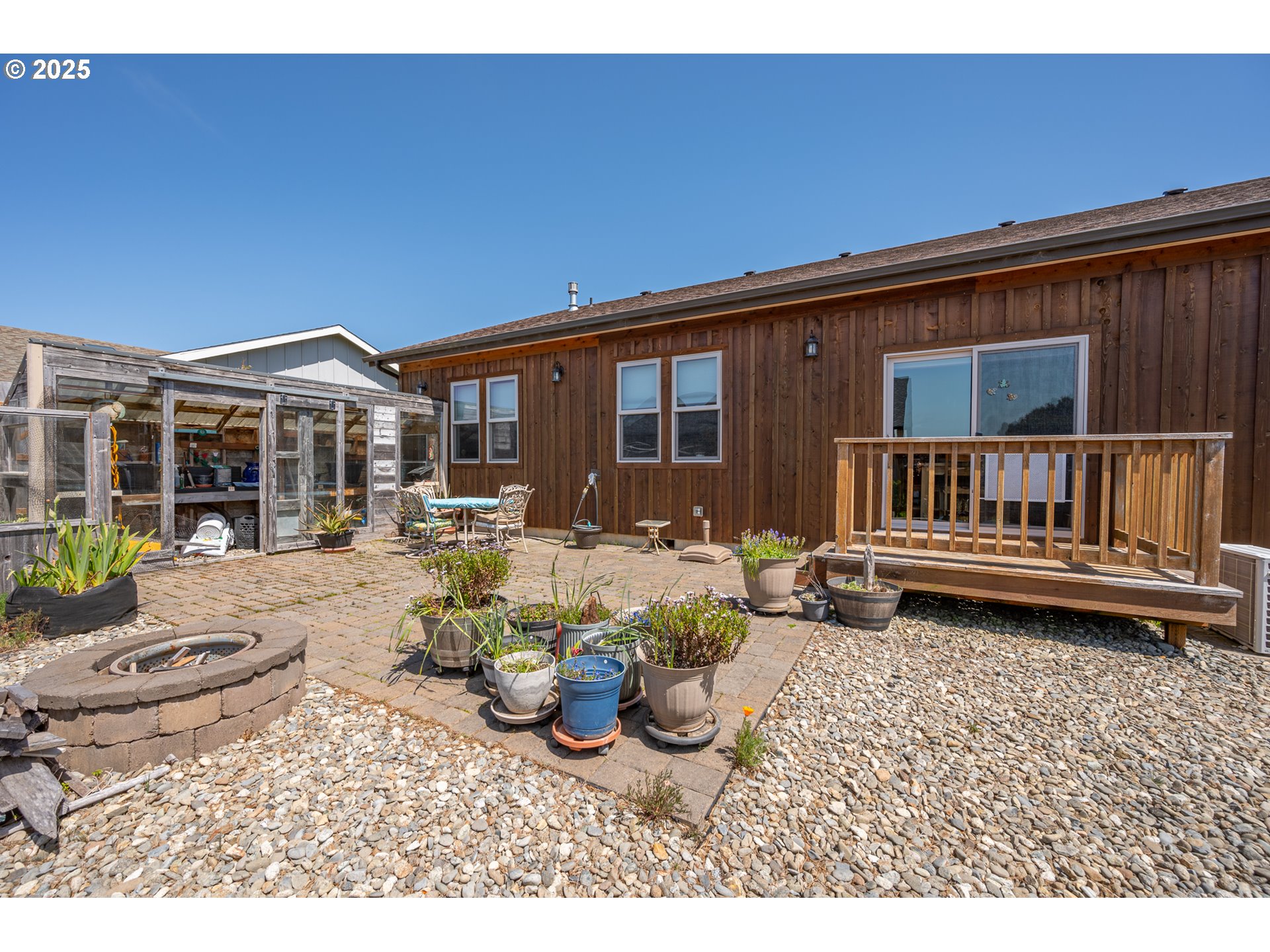 2686 Cedar Loop Bandon, OR 97411 - Photo 37 of 42 a view of a house with backyard and sitting area