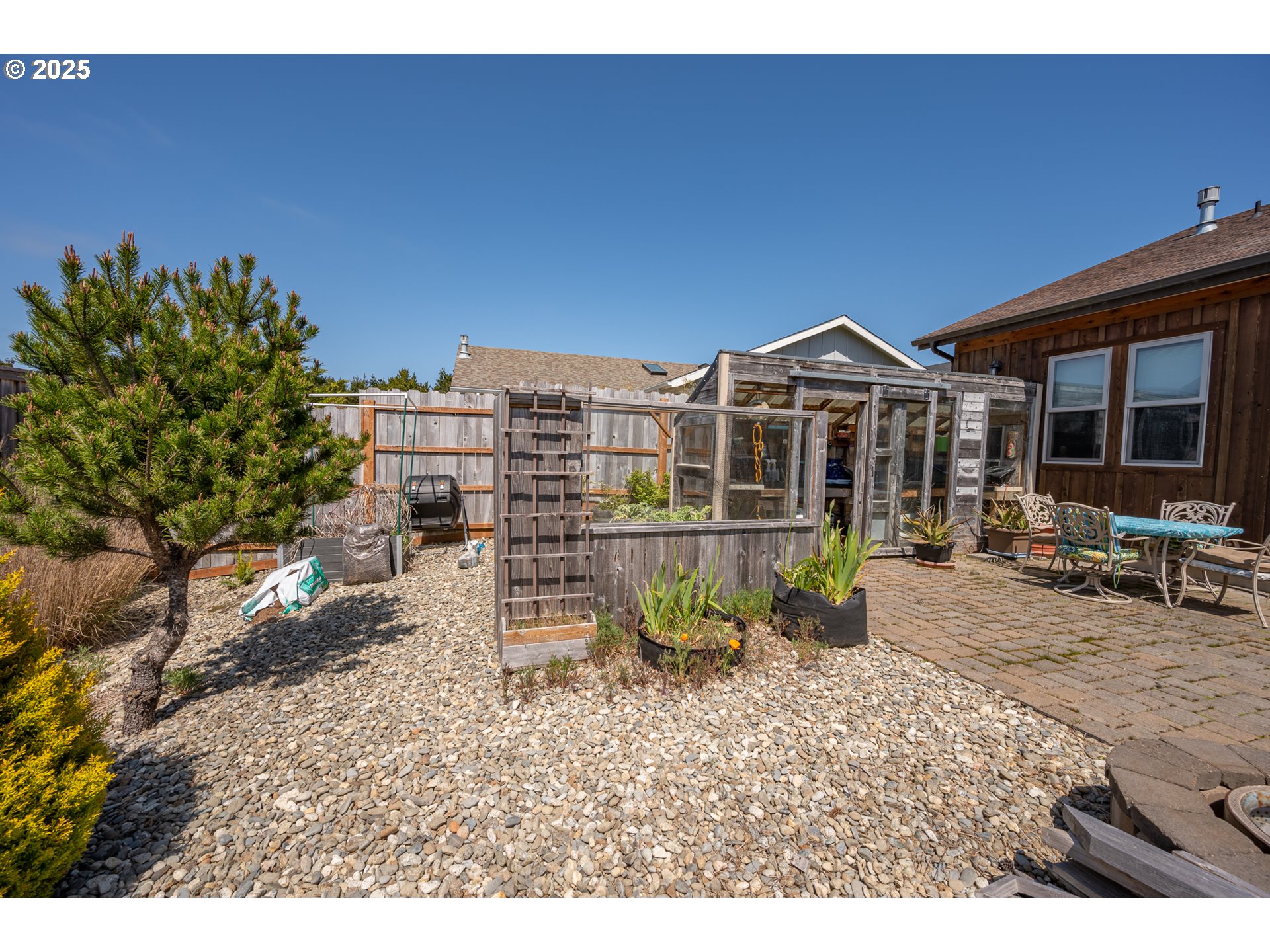 2686 Cedar Loop Bandon, OR 97411 - Photo 38 of 42 a view of a chairs and table in a backyard