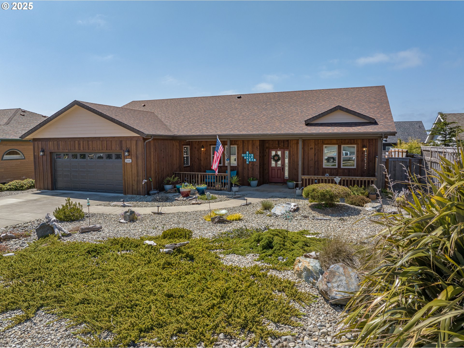 2686 Cedar Loop Bandon, OR 97411 - Photo 4 of 42 a front view of a house with swimming pool
