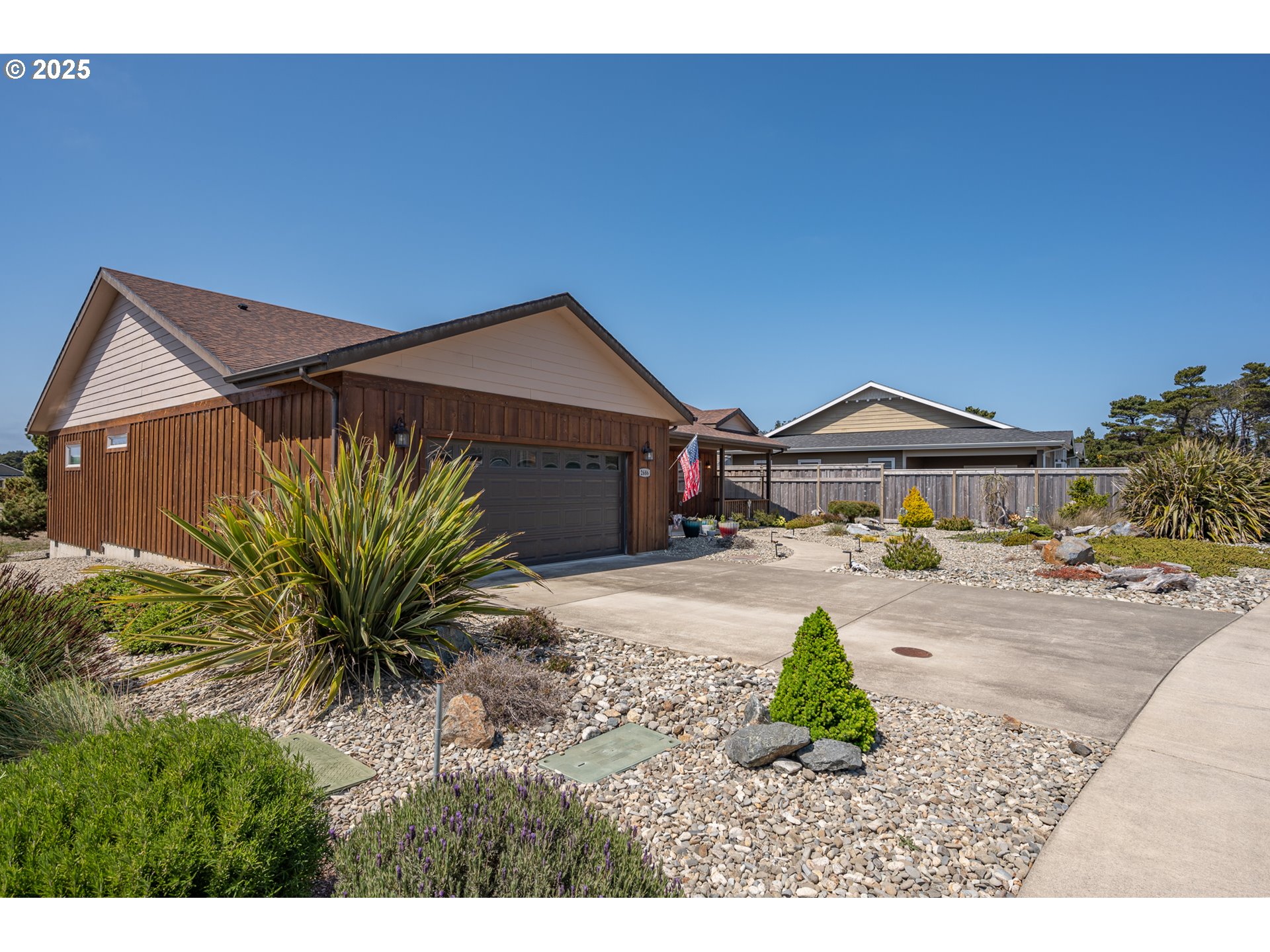 2686 Cedar Loop Bandon, OR 97411 - Photo 5 of 42 a front view of a house with garden