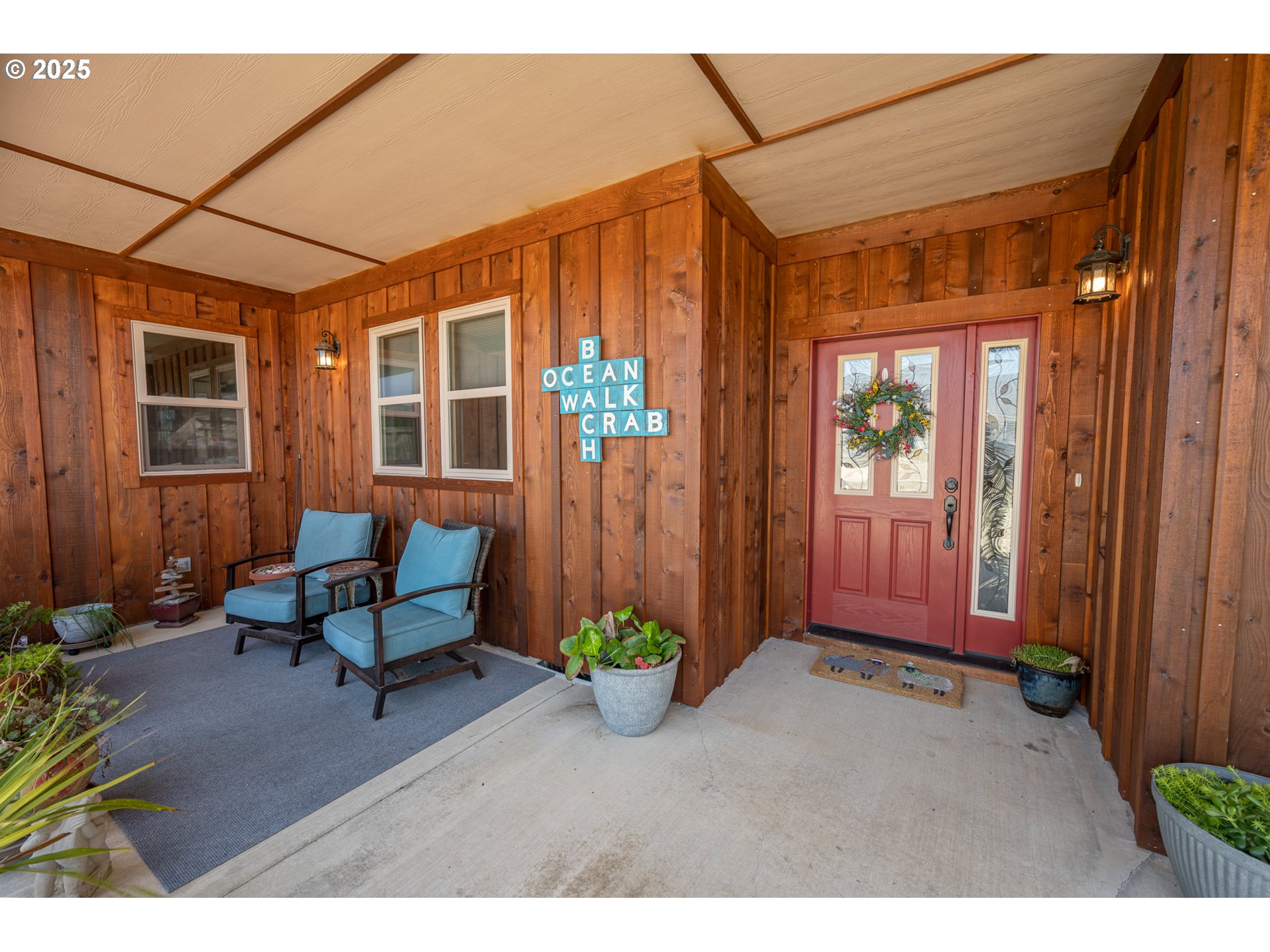 2686 Cedar Loop Bandon, OR 97411 - Photo 6 of 42 a front view of a house with a chairs and table in a patio