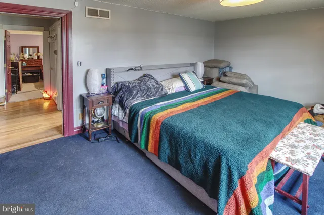 a bed sitting in a bedroom next to a window
