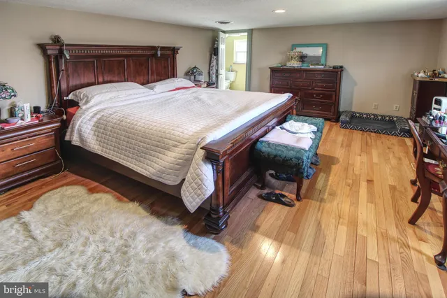 a spacious bedroom with a bed and a table in it