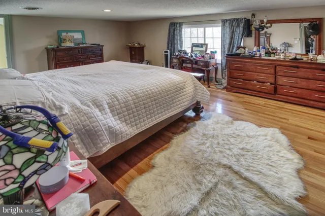a bedroom with a bed and a dresser in it