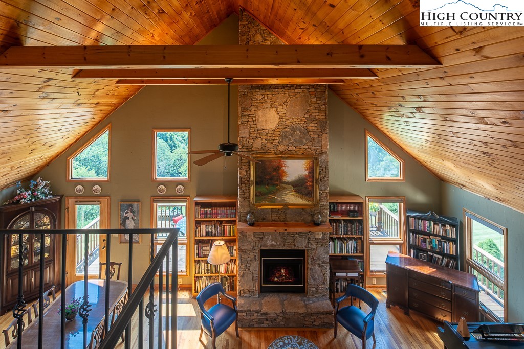 980 Scenic Drive Vilas, NC 28692 - Photo 19 of 42 a living room with fireplace furniture and a wooden floor
