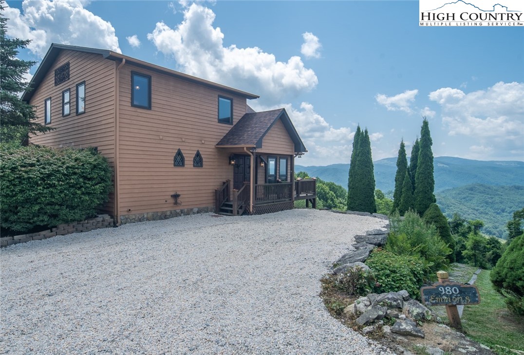 980 Scenic Drive Vilas, NC 28692 - Photo 2 of 42 a front view of a house with garden