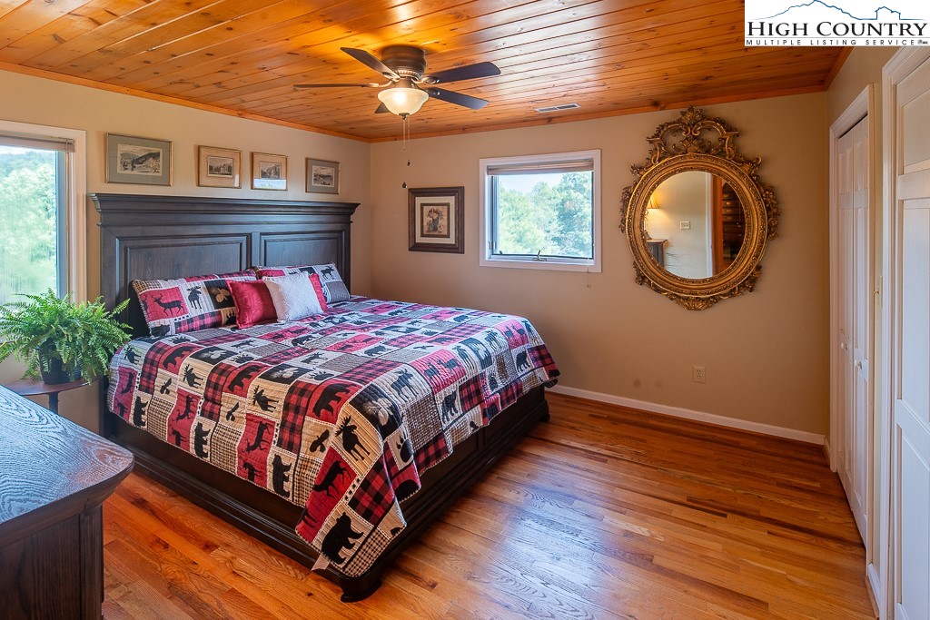 980 Scenic Drive Vilas, NC 28692 - Photo 21 of 42 a bedroom with a large bed and a chandelier