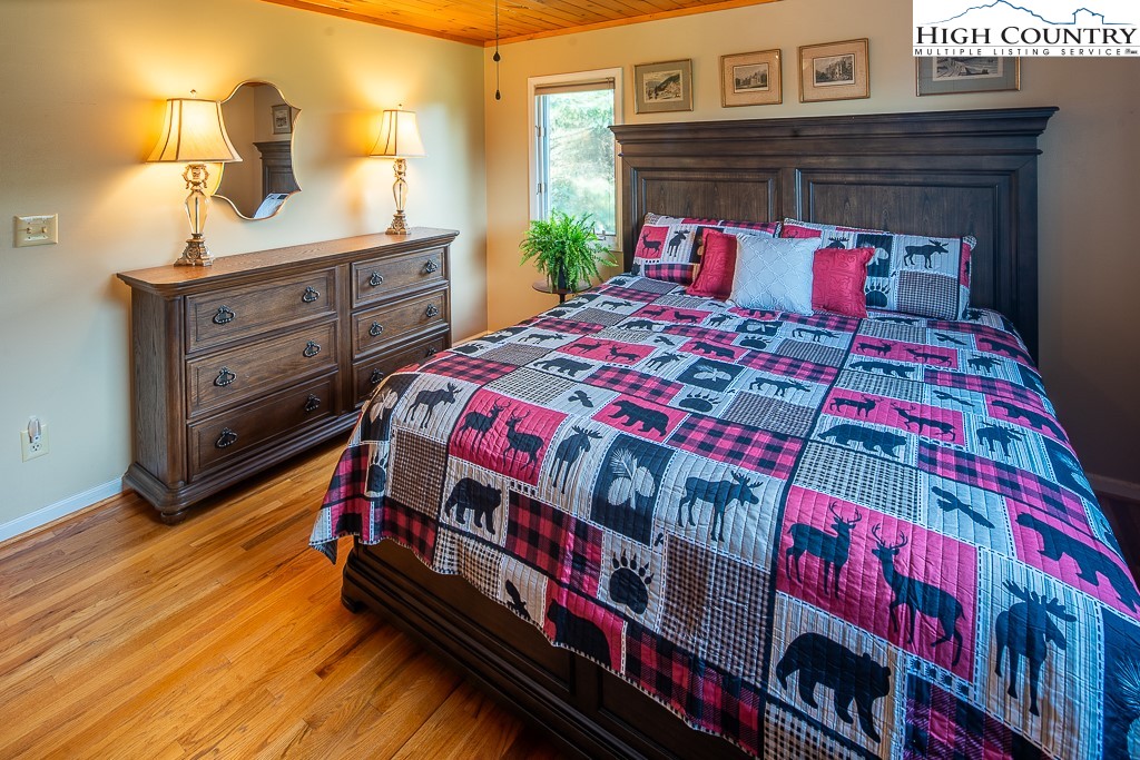 980 Scenic Drive Vilas, NC 28692 - Photo 22 of 42 a bedroom with a bed and a dresser in it