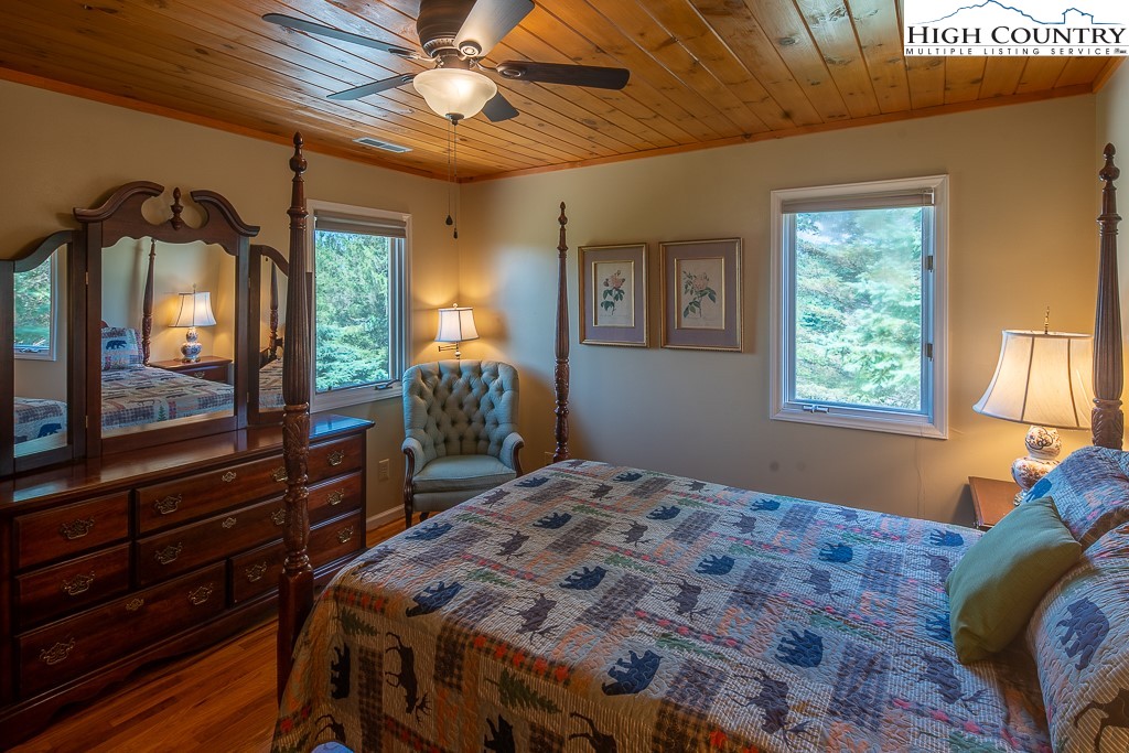 980 Scenic Drive Vilas, NC 28692 - Photo 23 of 42 a bedroom with a bed and a mirror on the dresser