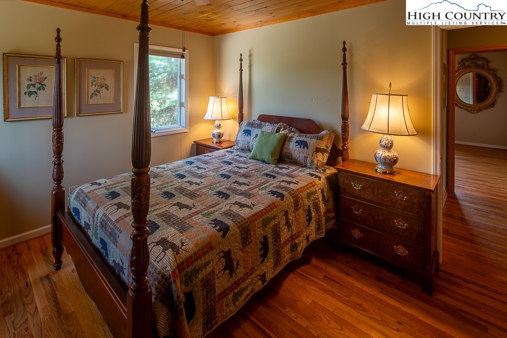 980 Scenic Drive Vilas, NC 28692 - Photo 24 of 42 a bedroom with a bed and a mirror on the dresser