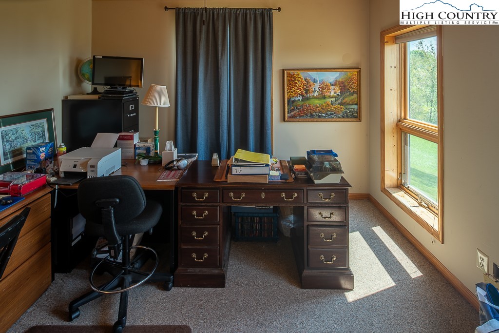 980 Scenic Drive Vilas, NC 28692 - Photo 28 of 42 a room with furniture a flat screen tv and a window