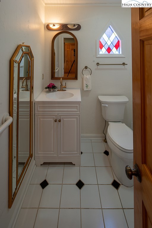 980 Scenic Drive Vilas, NC 28692 - Photo 30 of 42 a bathroom with a toilet sink and mirror