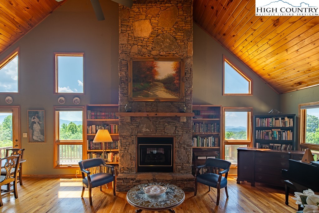 980 Scenic Drive Vilas, NC 28692 - Photo 3 of 42 a living room with furniture a fireplace and a flat screen tv