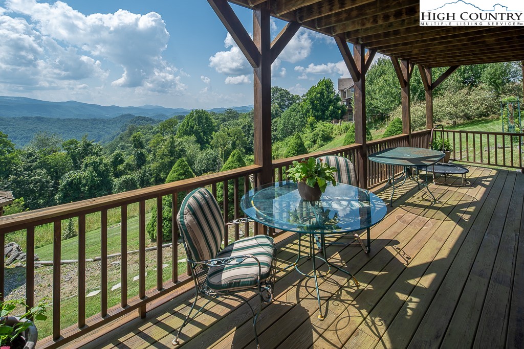 980 Scenic Drive Vilas, NC 28692 - Photo 36 of 42 a view of a balcony with wooden floor and outdoor seating
