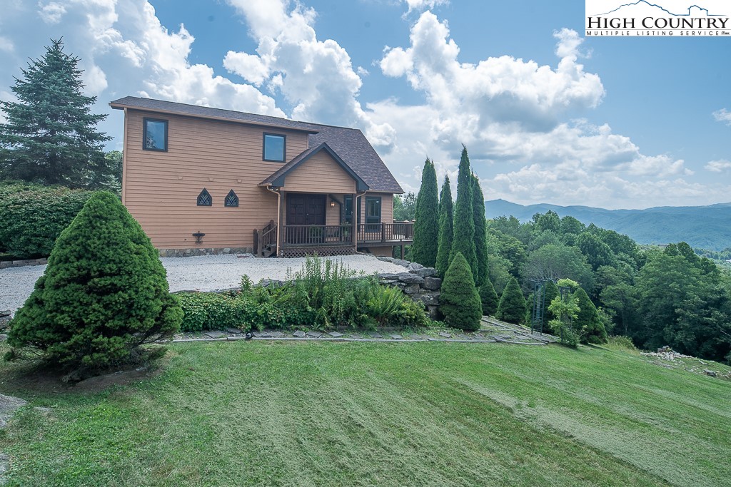 980 Scenic Drive Vilas, NC 28692 - Photo 40 of 42 a front view of a house with garden