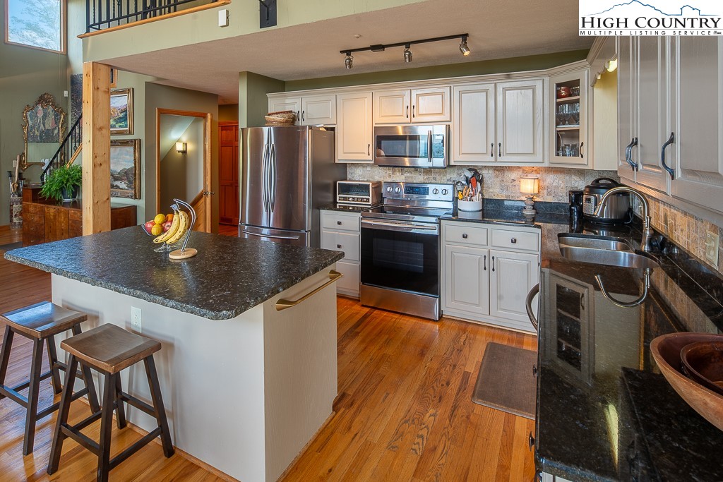 980 Scenic Drive Vilas, NC 28692 - Photo 4 of 42 a kitchen with stainless steel appliances granite countertop a sink a stove and a refrigerator
