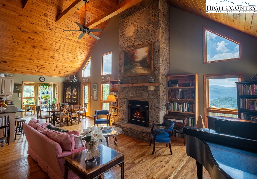 980 Scenic Drive Vilas, NC 28692 - Photo 5 of 42 a living room with furniture a fireplace and a flat screen tv