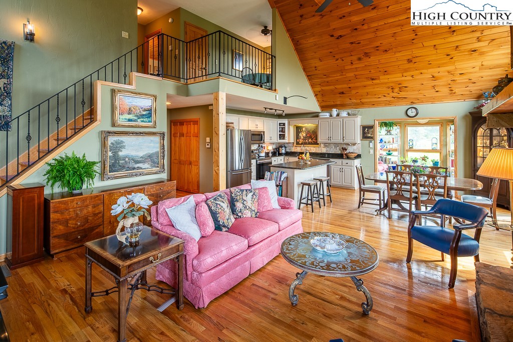 980 Scenic Drive Vilas, NC 28692 - Photo 7 of 42 a living room with furniture a wooden floor and a chandelier