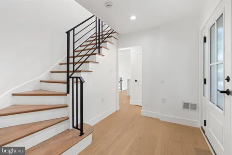 a view of entryway with wooden floor and stairs