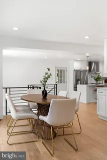a view of a kitchen with a sink and dishwasher a refrigerator with wooden floor