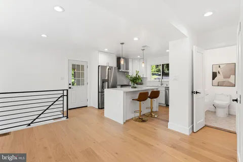 a view of a living room hardwood floor and a window