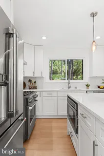 a kitchen with white cabinets and white appliances