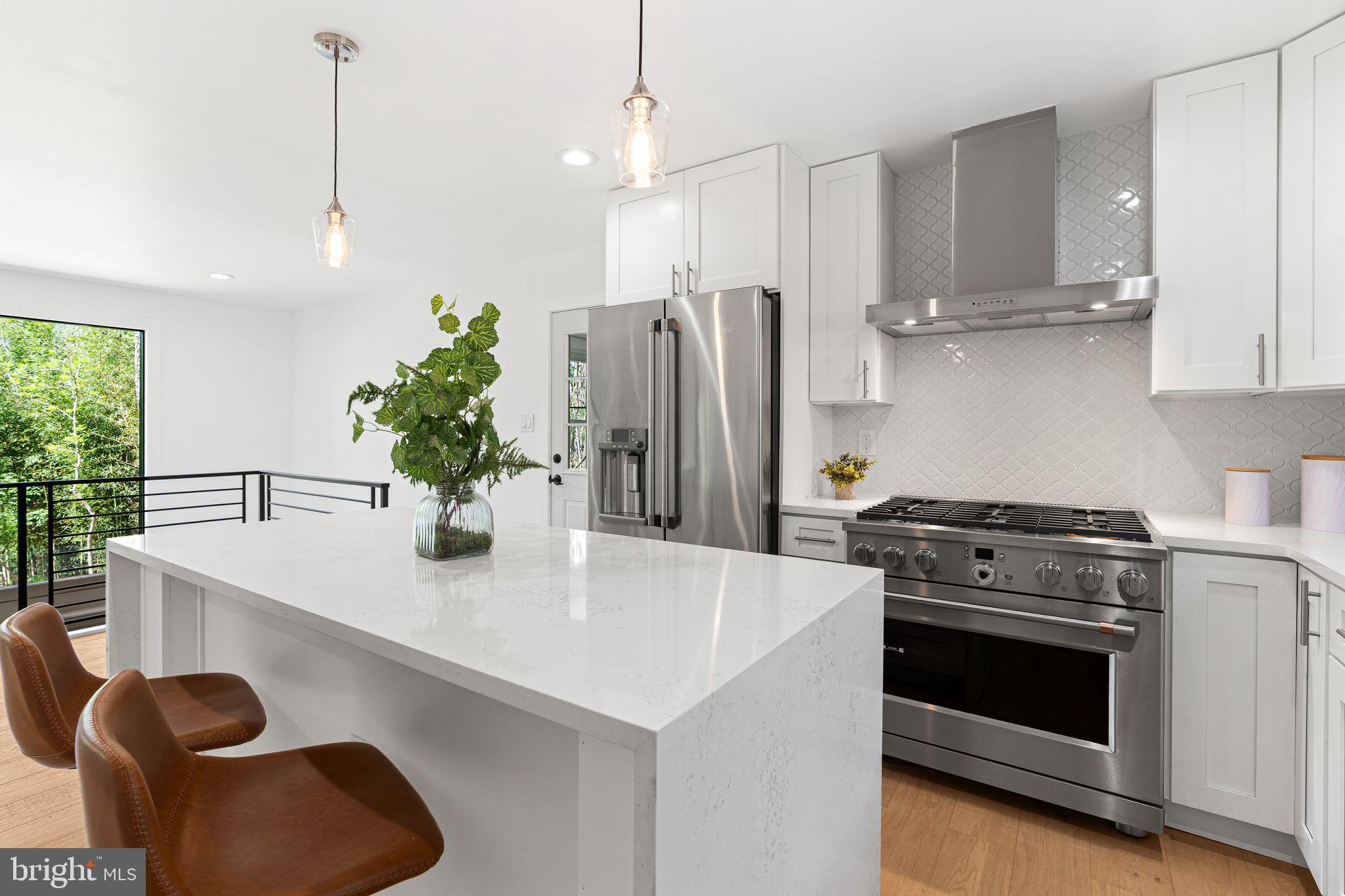 726 Darby Paoli Road Newtown Square, PA 19073 - Photo 31 of 55 a kitchen with stainless steel appliances granite countertop a sink a stove and a refrigerator