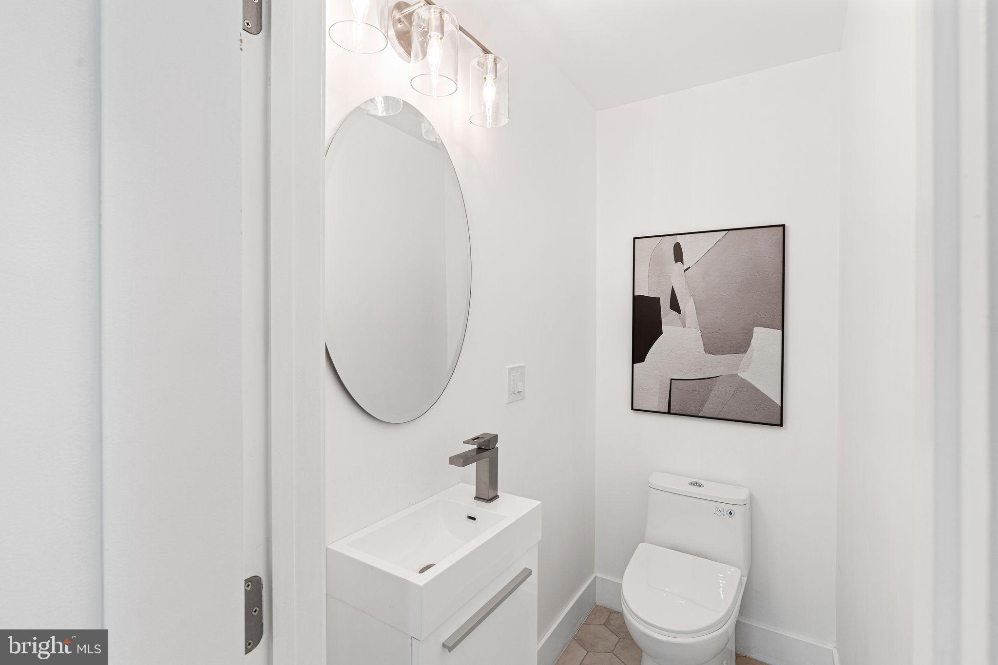 726 Darby Paoli Road Newtown Square, PA 19073 - Photo 32 of 55 a bathroom with a toilet sink and mirror