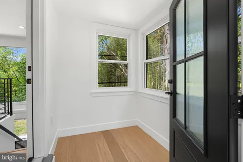 a view of a floor to ceiling window and wooden floor