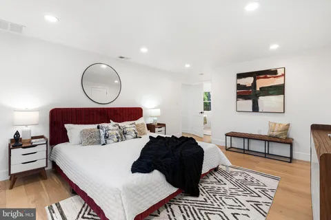 a bedroom with furniture and a flat screen tv