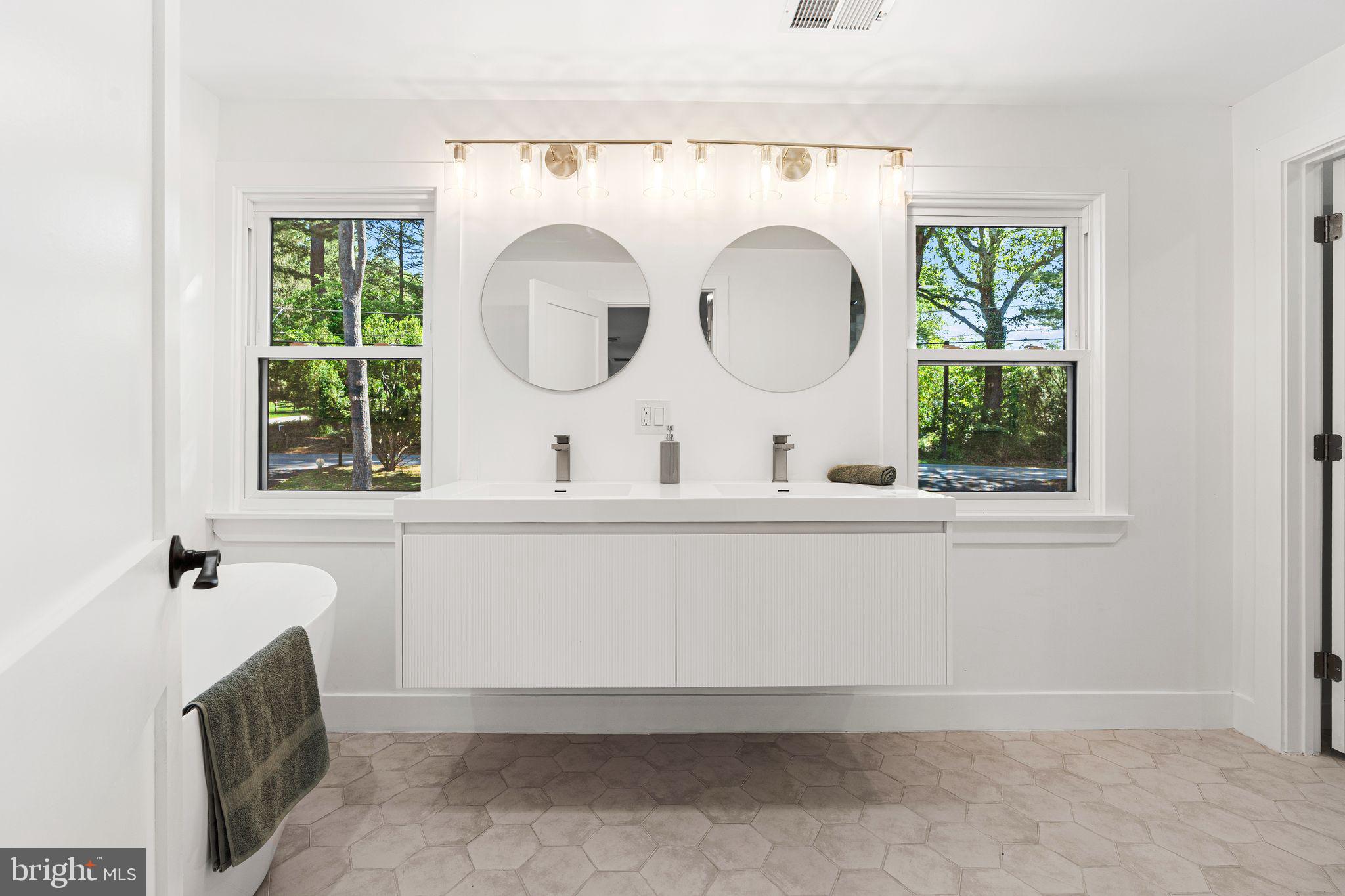 726 Darby Paoli Road Newtown Square, PA 19073 - Photo 40 of 55 a bathroom with a sink a mirror and window