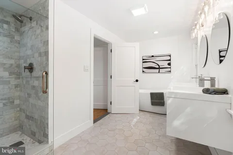 a bathroom with a double vanity sink and a mirror