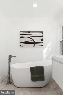 a bathroom with a toilet a sink and a mirror