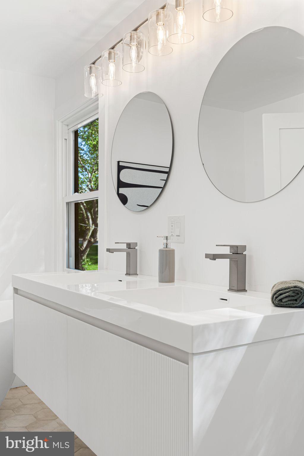 726 Darby Paoli Road Newtown Square, PA 19073 - Photo 44 of 55 a bathroom with a double vanity sink and a mirror