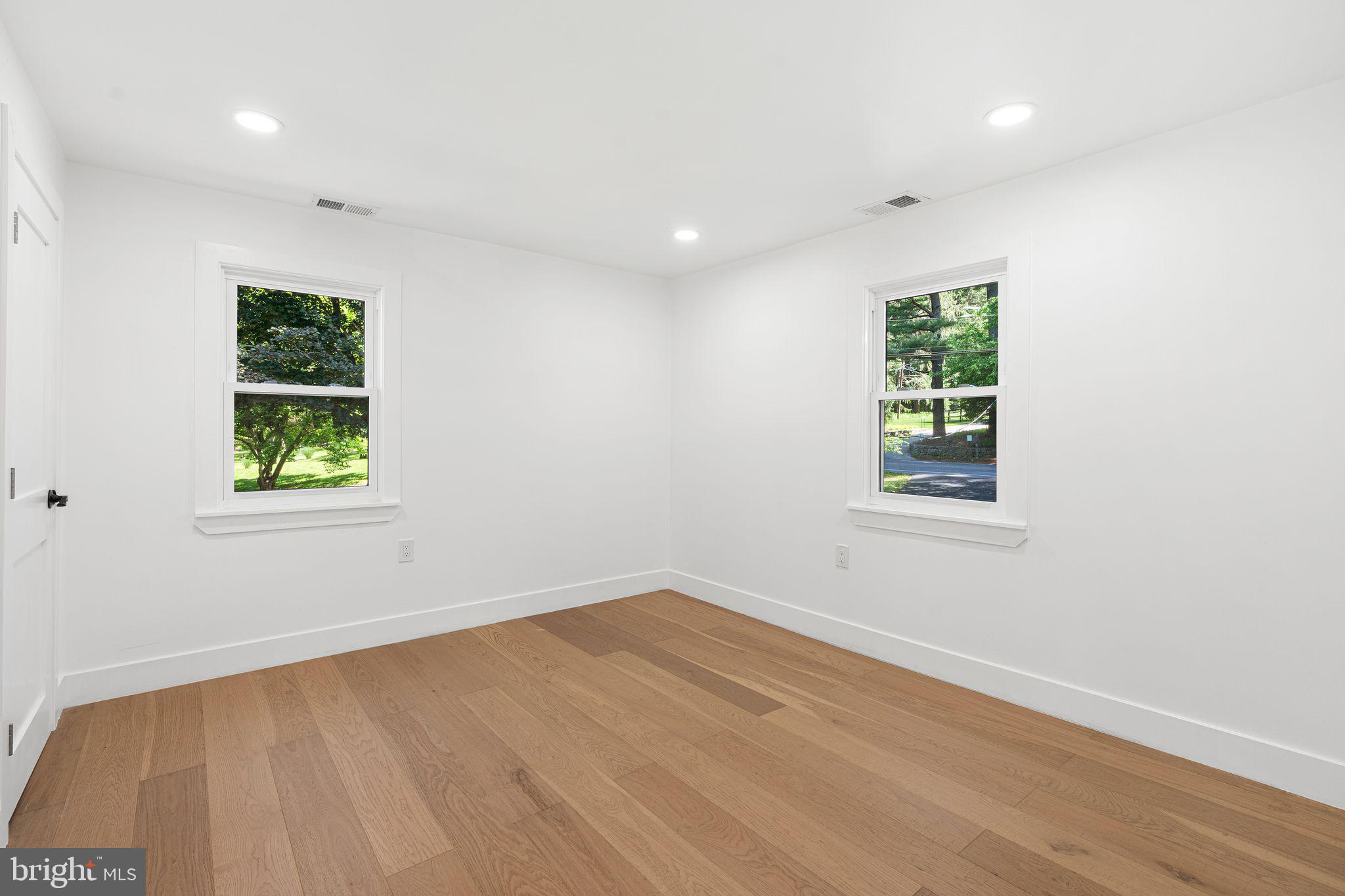 726 Darby Paoli Road Newtown Square, PA 19073 - Photo 48 of 55 an empty room with wooden floor and windows