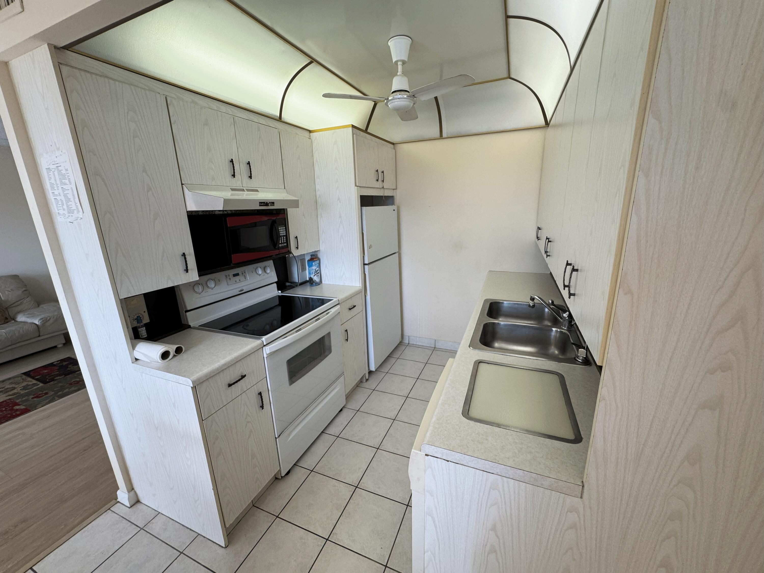 4075 Cornwall East Boca Raton, FL 33434 - Photo 6 of 30 a kitchen with a stove and a sink