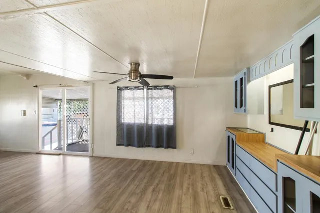 a view of hallway with wooden floor and furniture