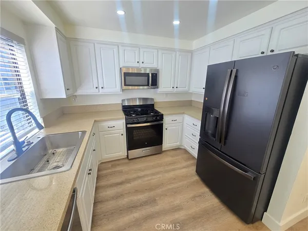a kitchen with stainless steel appliances a refrigerator stove and sink