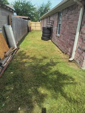 a backyard of a house with table and chairs