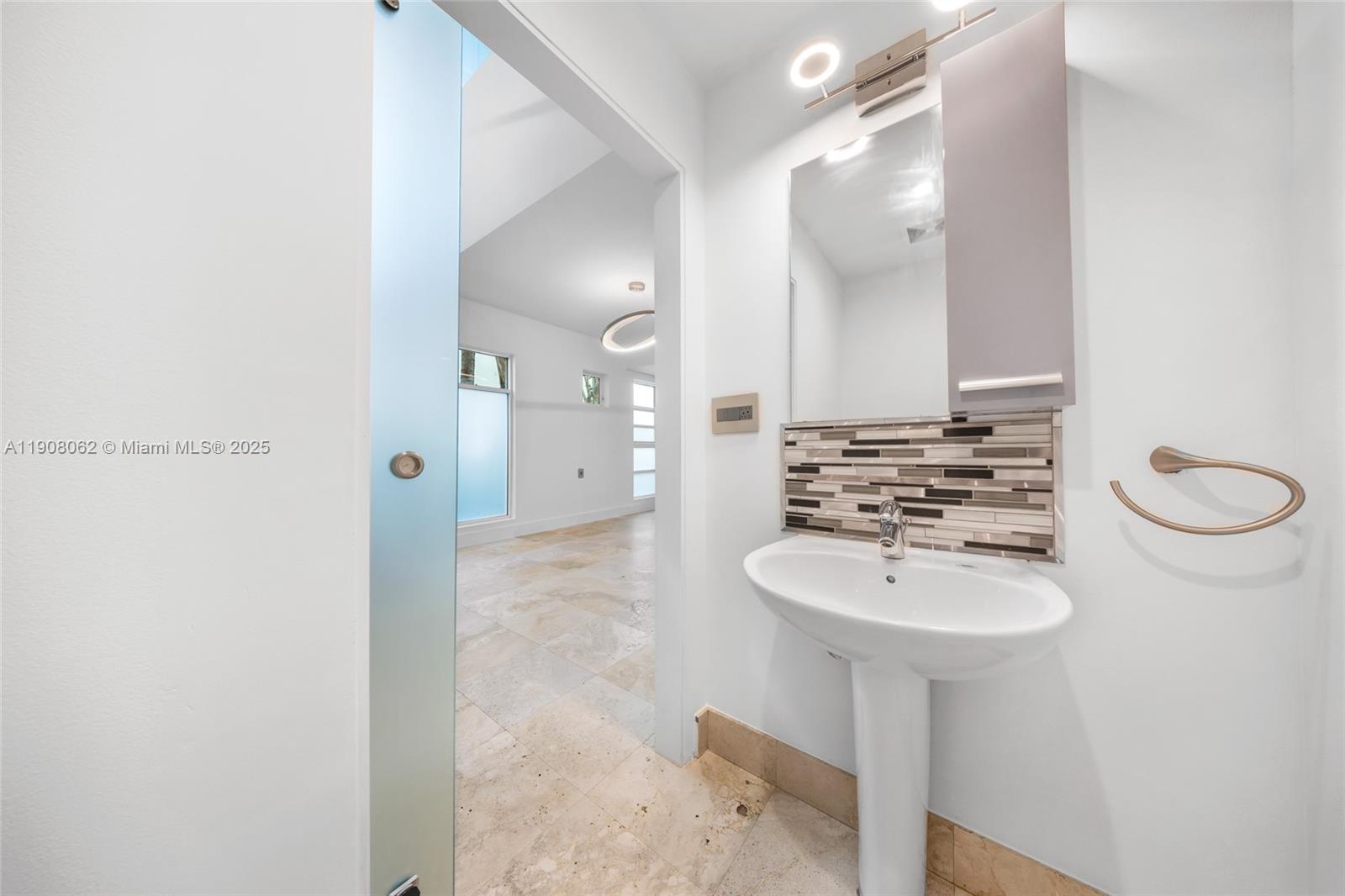 1545 Jefferson Avenue, Unit 103 Miami Beach, FL 33139 - Photo 13 of 35 a bathroom with a sink a mirror and a shower