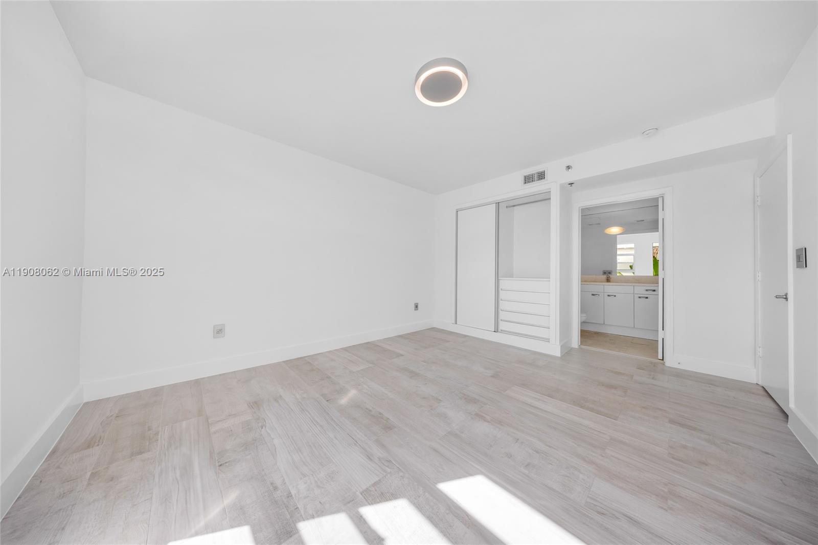 1545 Jefferson Avenue, Unit 103 Miami Beach, FL 33139 - Photo 23 of 35 a view of an empty room with wooden floor and closet