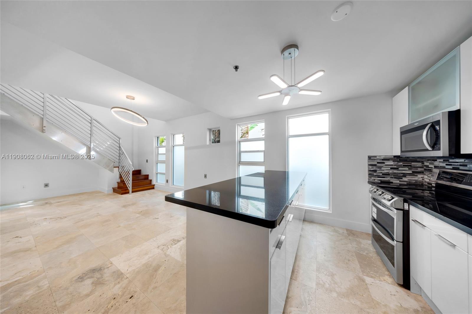 1545 Jefferson Avenue, Unit 103 Miami Beach, FL 33139 - Photo 5 of 35 a kitchen with stainless steel appliances granite countertop a sink and a stove