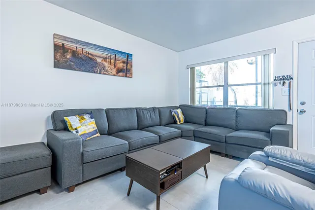 a living room with furniture and a window