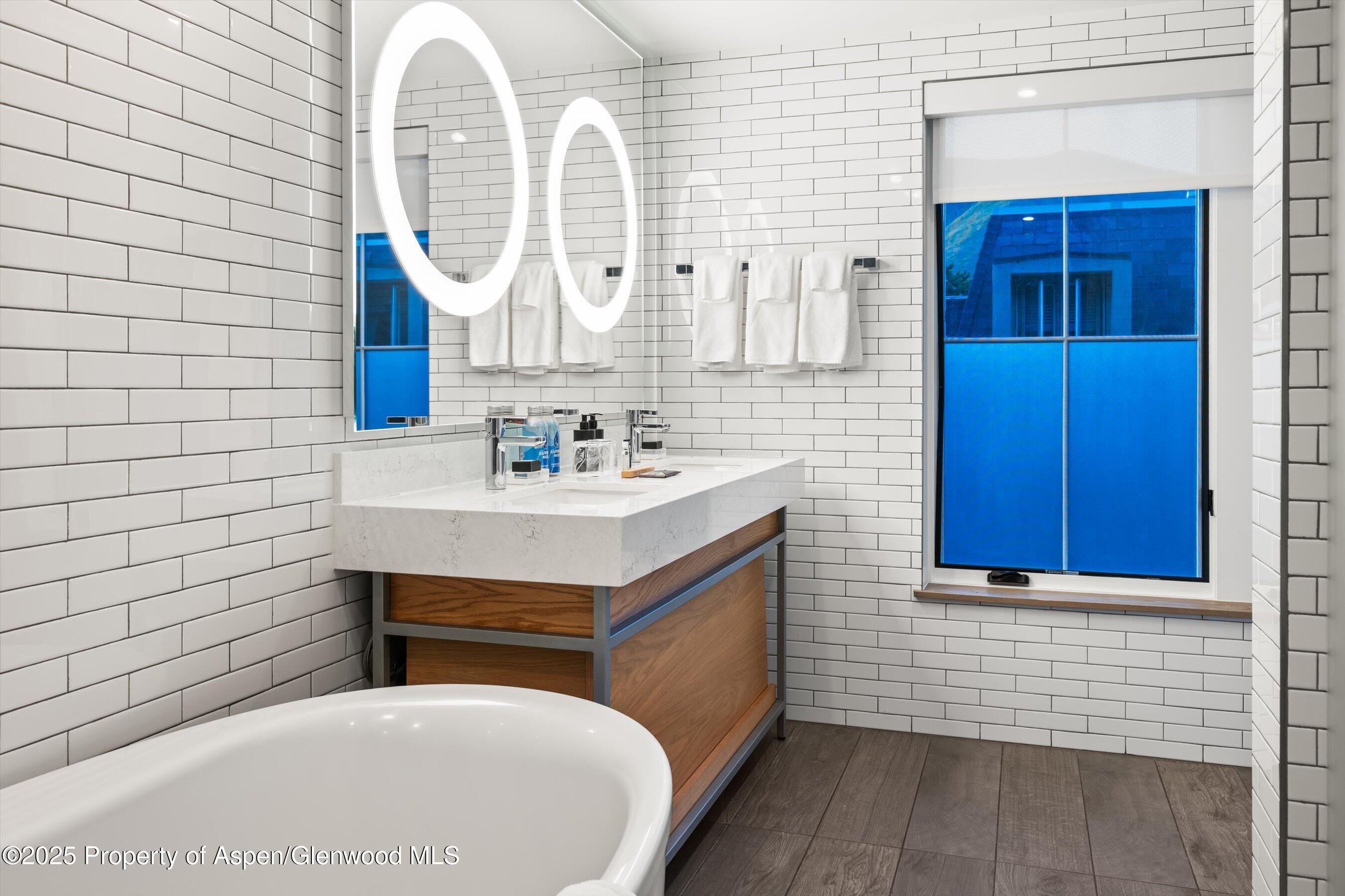 550 South Spring Street, Unit F10 110 Aspen, CO 81611 - Photo 28 of 58 a bathroom with a sink and a mirror