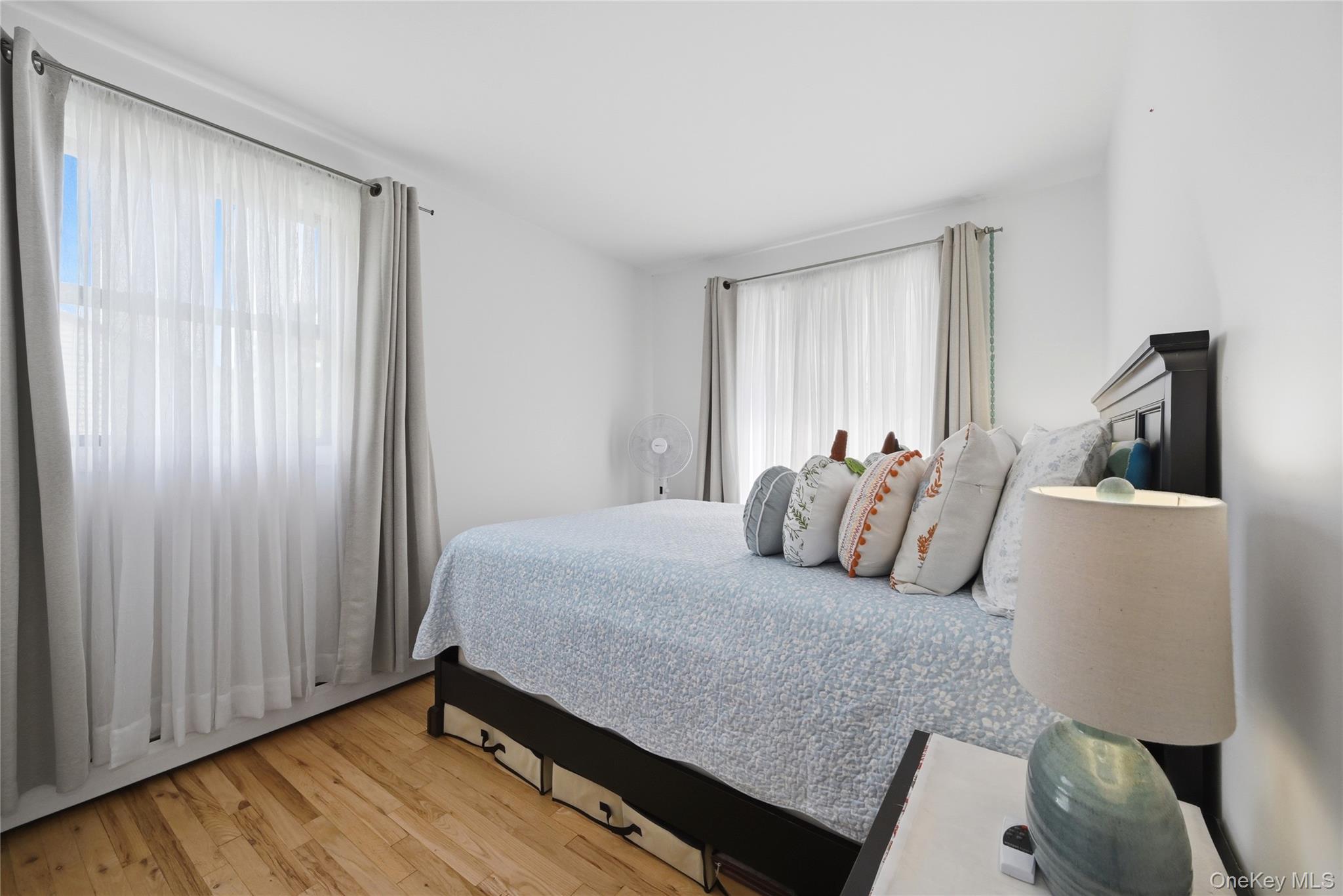 35 Randall Road Shoreham, NY 11786 - Photo 14 of 32 a bedroom with a bed and wooden floor